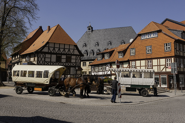 Two horse-drawn carriages by the flower clock on the Marktstraße, Wernigerode